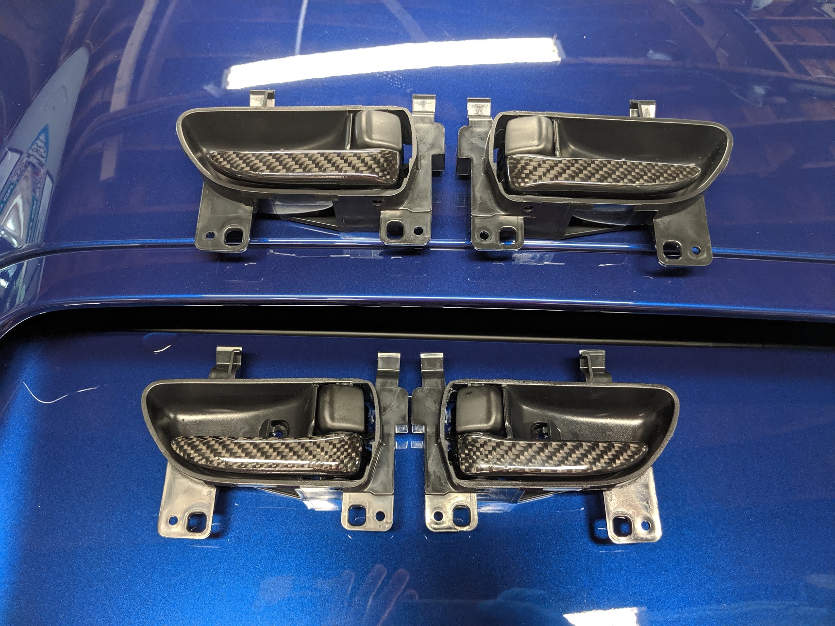 Carbon wrapped door handles