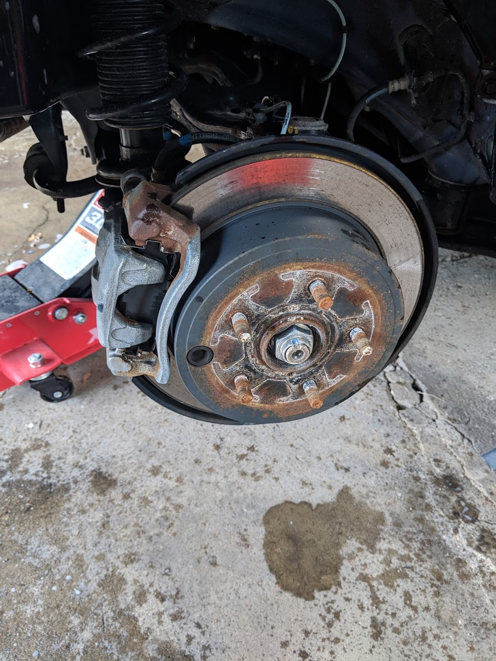 The stock, rusted WRX calipers