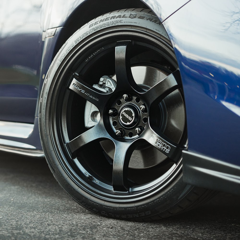 The painted calipers pop against dark wheels